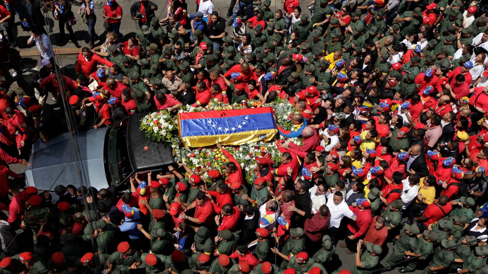 cheats/2013/03/06/thousands-march-with-chavez-coffin/130306-Kennedy-Chavez-Death-tease_oa7vf5