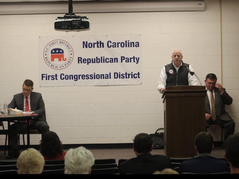 West sits behind Whatley as he speaks in North Carolina.