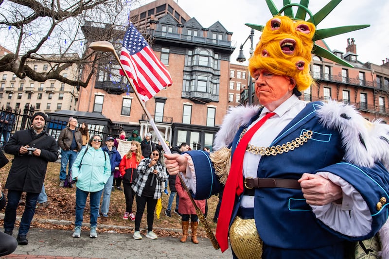 A person dressed up as "king Trump" in Boston
