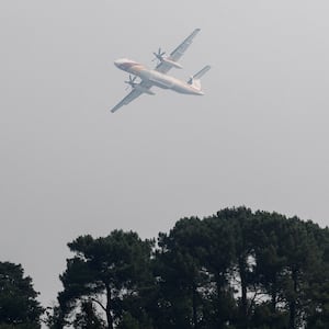 Aerial firefighting plane, De Havilland Canada Dash 8-402 MR, flies as French firefighters battle a wildfire in the Fontainebleau forest in in Noisy-sur-Ecole near Paris, amid a heatwave affecting a large part of the country, France, July 13, 2026.