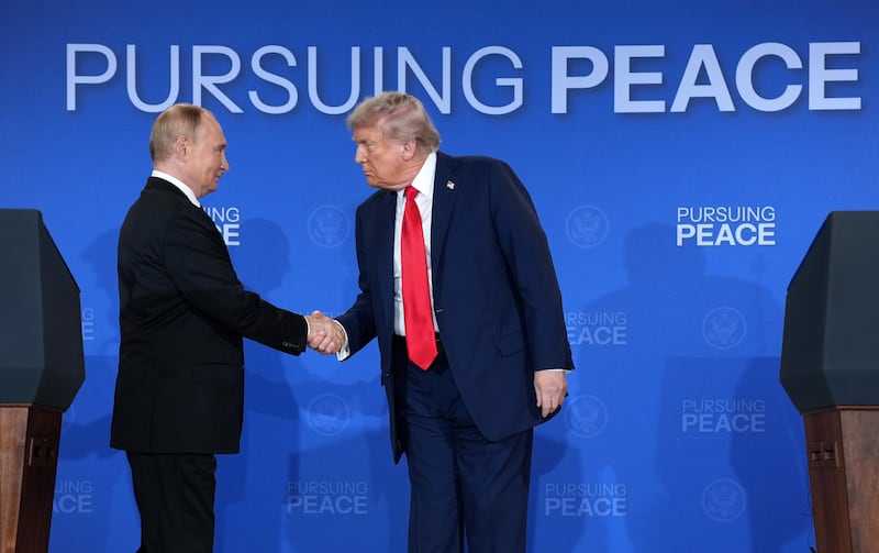 U.S. President Donald Trump (R) and Russian President Vladimir Putin shake hands at the end of a press conference at Joint Base Elmendorf-Richardson on August 15, 2025 in Anchorage, Alaska.