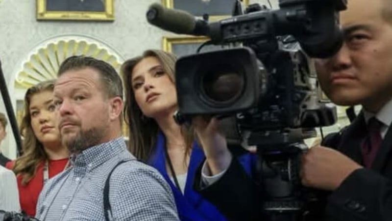 Beni Rae Harmony (head tilted, next to camera lens) in the Oval Office.