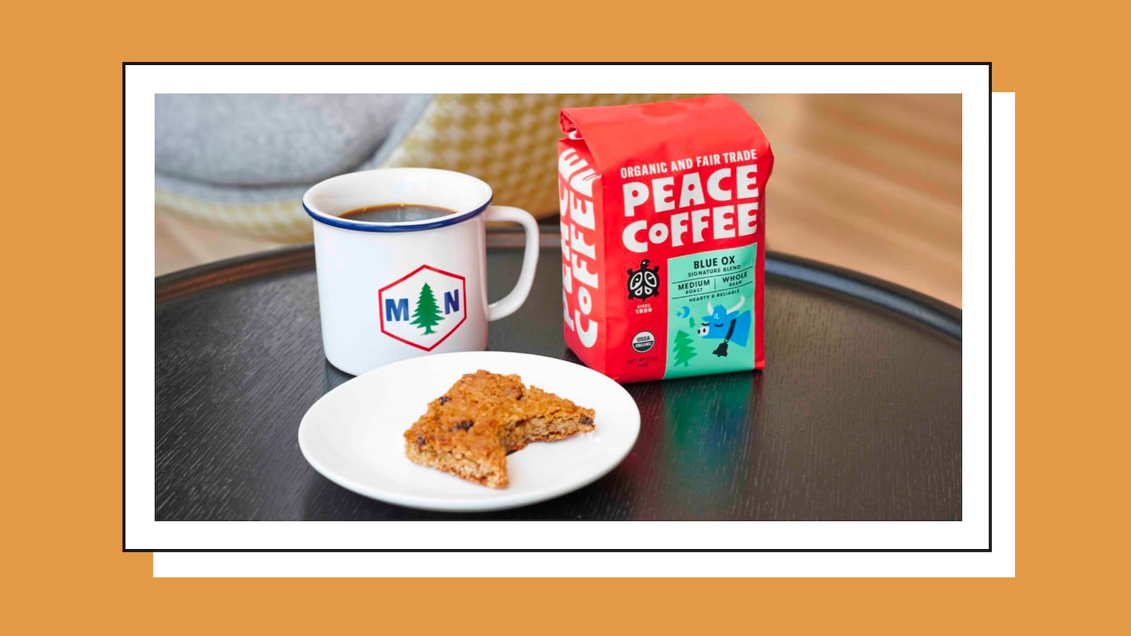 Package of coffee grains alongside a mug and plate.