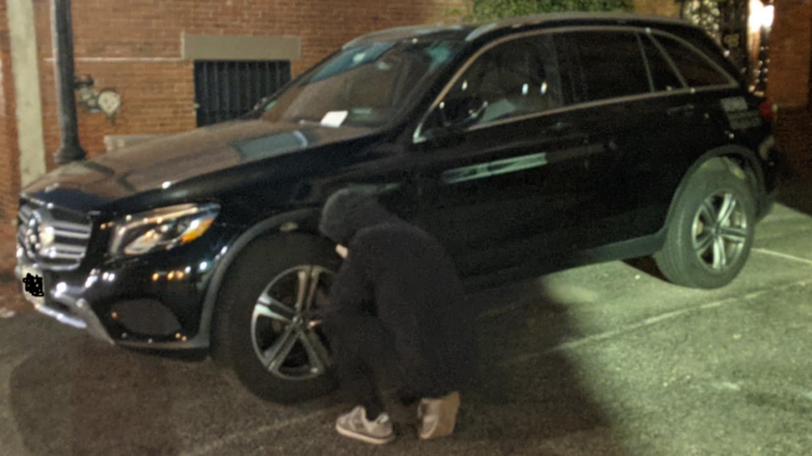 An activist deflating the tires of an SUV in Boston.