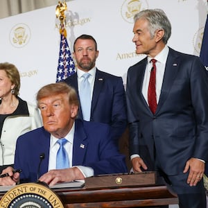 WASHINGTON, DC - SEPTEMBER 29: U.S. President Donald Trump signs an executive order during the America.gov launch event at Andrew W. Mellon Auditorium on September 29, 2026 in Washington, DC. The website features an artificial intelligence tool to help Americans interact with the federal government. The event was attended by tech leaders Elon Musk, Nvidia CEO Jensen Huang and Blue Origin CEO Dave Limp, along with U.S. Vice President JD Vance and U.S. Secretary of State Marco Rubio. (Photo by Kevin Dietsch/Getty Images)