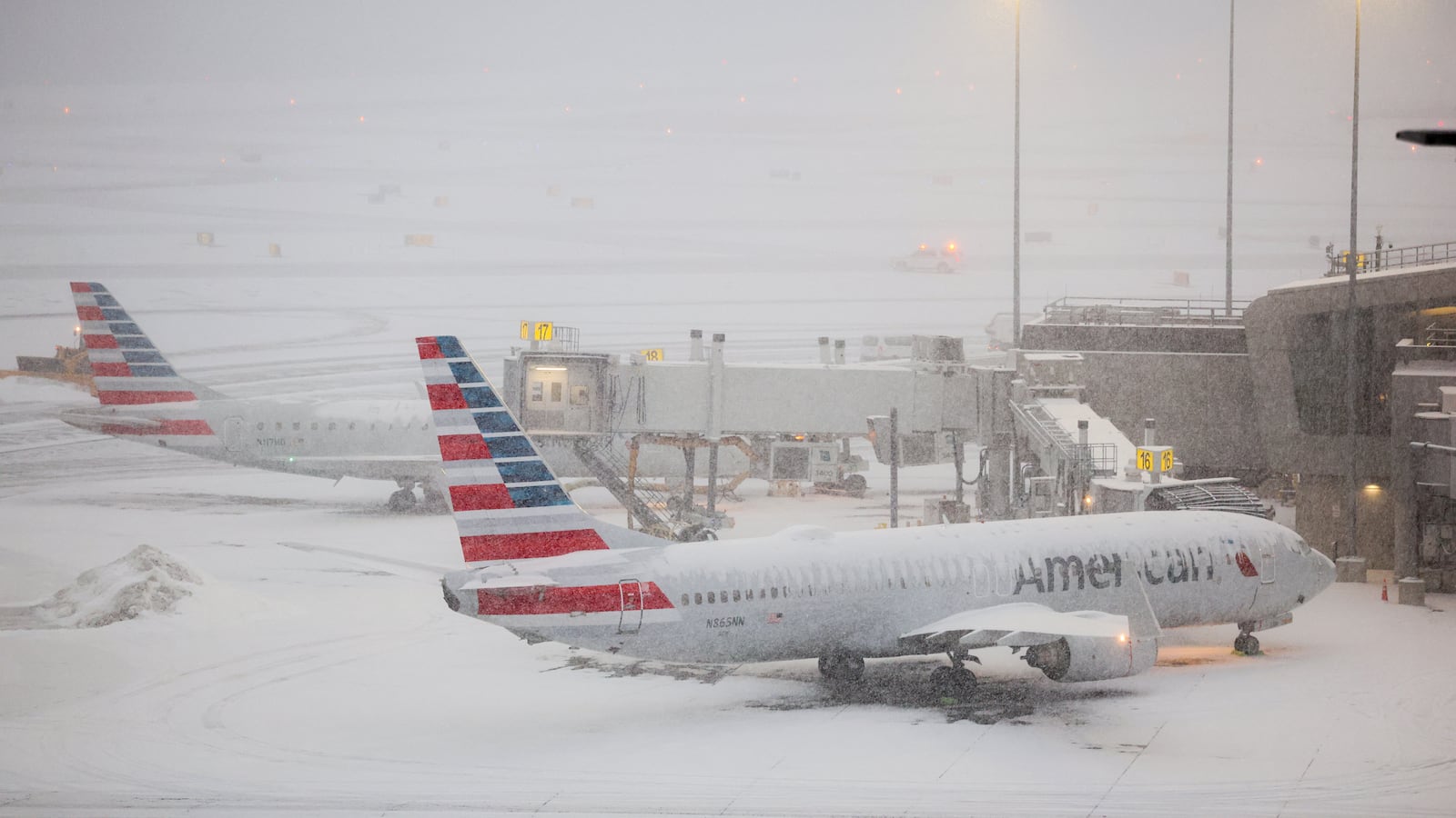 A Boeing 737 American Airlines passenger aircraft is parked at gate on the tarmac of LaGuardia airport in New York on January 25, 2026. A massive winter storm on January 24, 2026 dumped snow and freezing rain on New Mexico and Texas as it swept across the United States towards the northeast, threatening tens of millions of Americans with blackouts, transportation chaos and bone-chilling cold. Shoppers stripped supermarket shelves as the National Weather Service (NWS) forecast huge snowfall in some areas and possibly "catastrophic" ice accumulations. (