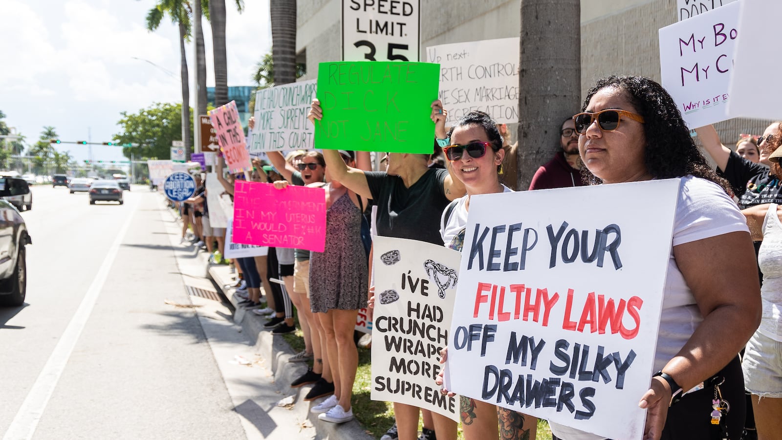 An abortion rights activist holds a sign at a protest in support of abortion access