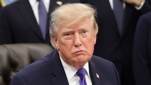 Donald Trump answers questions from reporters during an announcement in the Oval Office at the White House.