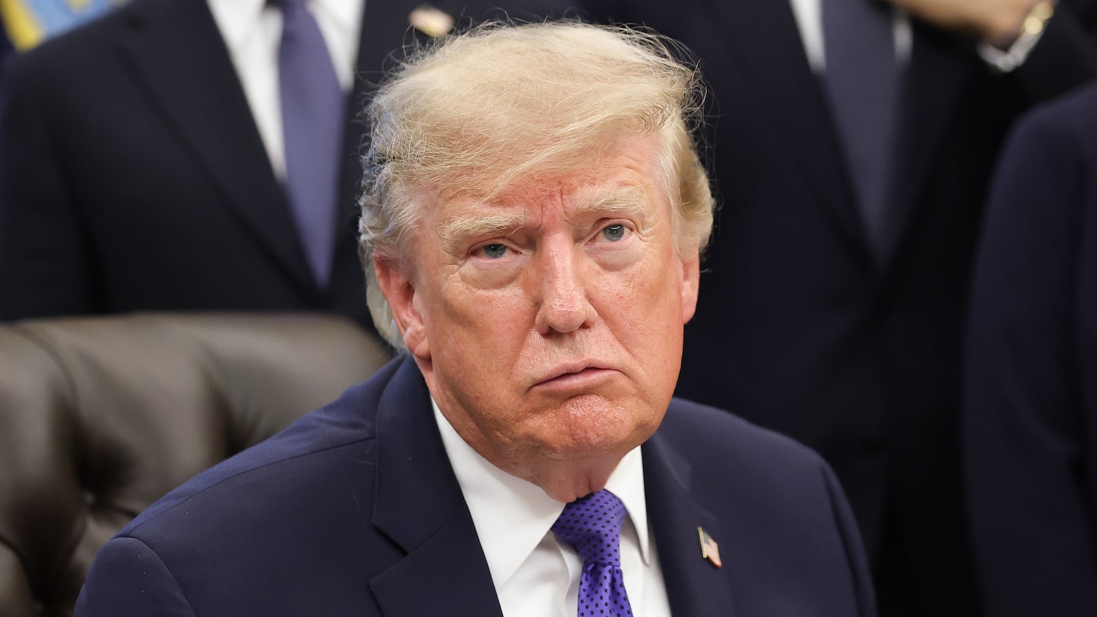 Donald Trump answers questions from reporters during an announcement in the Oval Office at the White House.