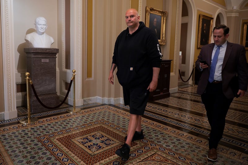 Sen. John Fetterman wears sweatpants walking through the U.S. Capitol between votes in Washington, DC.