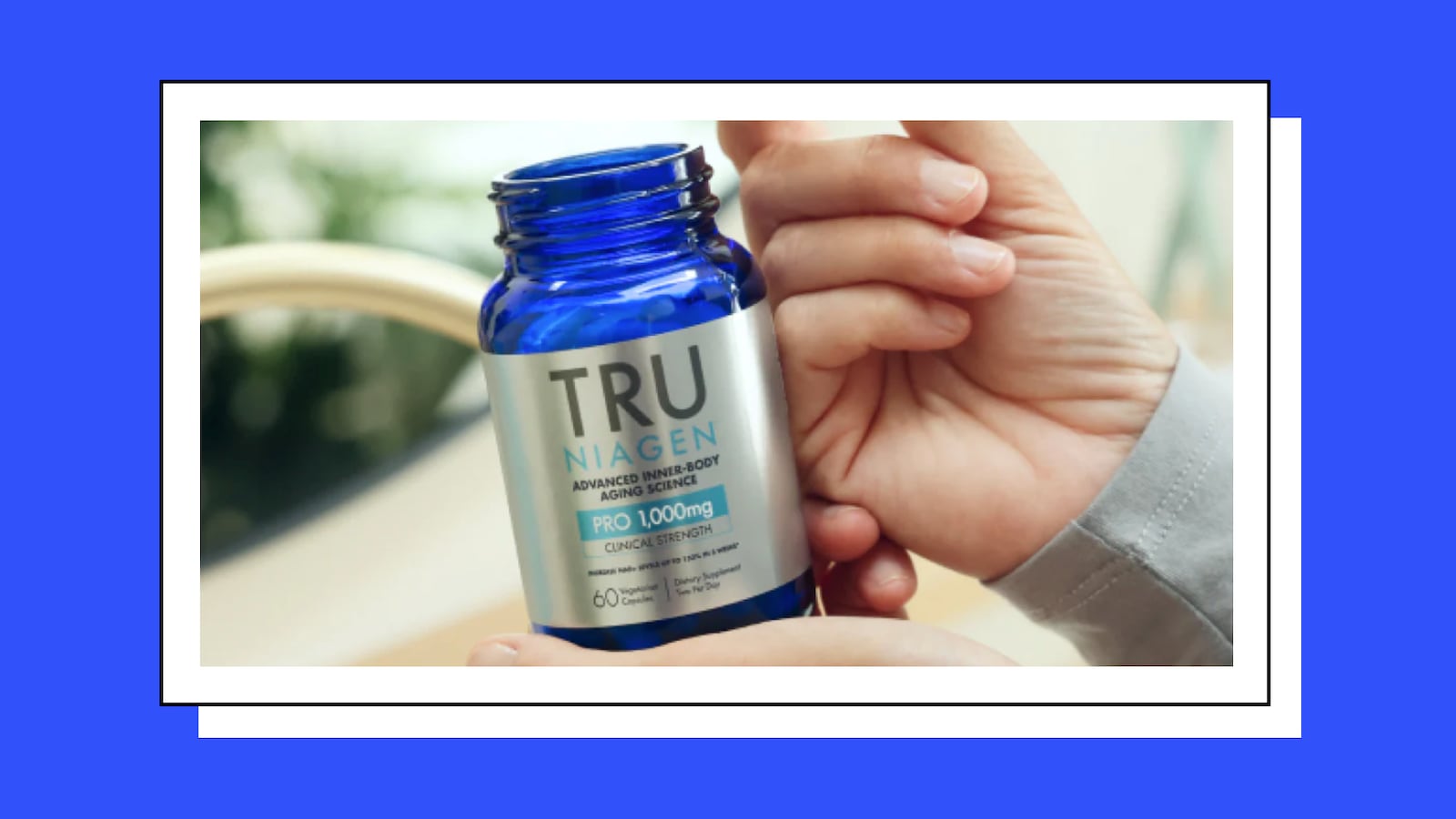 Hands holding a blue bottle of Tru Niagen Pro 1000mg, an advanced NAD+ supplement for inner-body aging science