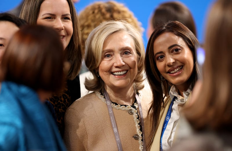 Former US Secretary of State Hillary Clinton (C) poses for a selfie with women at the 62nd Munich Security Conference (MSC) on February 14, 2026, in Munich, southern Germany.