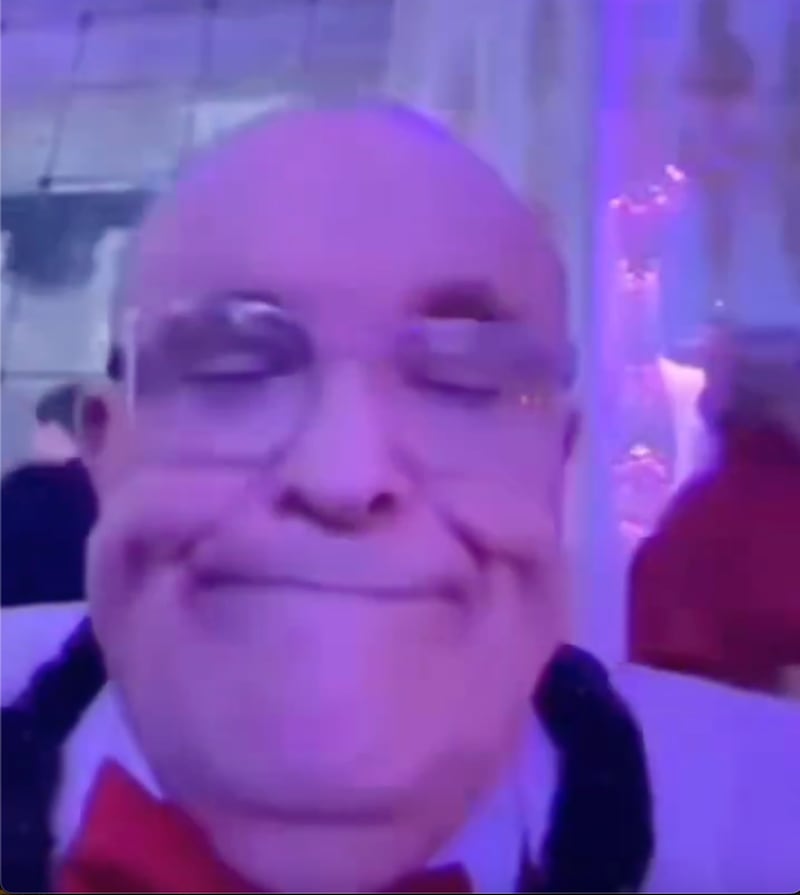 Giuliani looked fed up at his inability to use his camera properly.