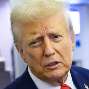 US President Donald Trump, watched by White House Press Secretary Karoline Leavitt, speaks to reporters while in flight on Air Force One en route Joint Base Andrews, on January 27, 2025. (Photo by Mandel NGAN / AFP) (Photo by MANDEL NGAN/AFP via Getty Images)