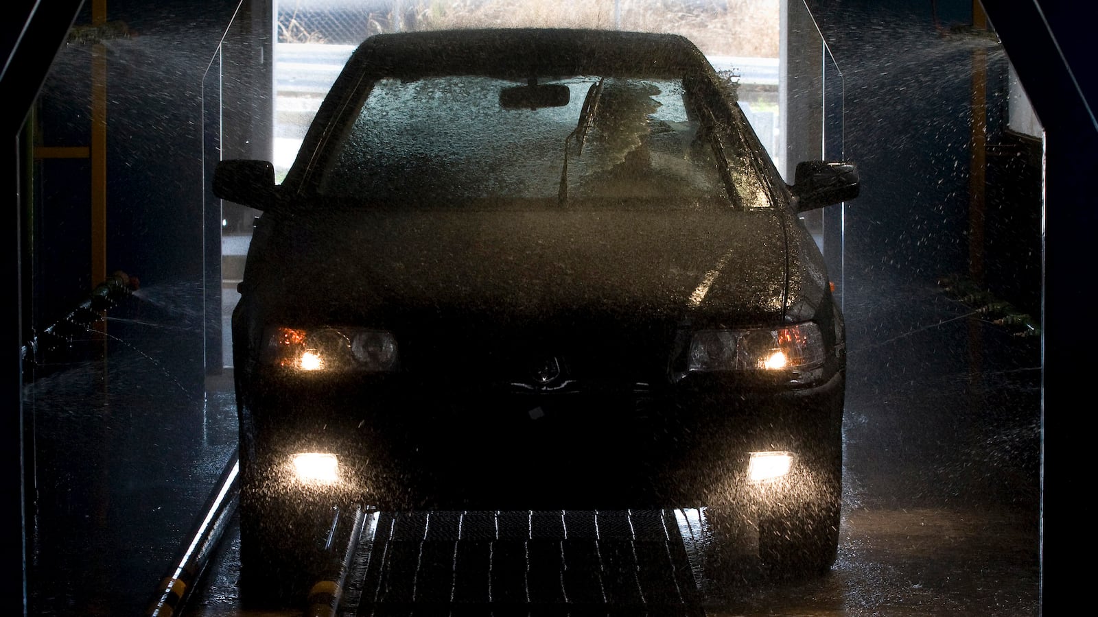 A new car is washed in a Venirauto car manufacturing plant