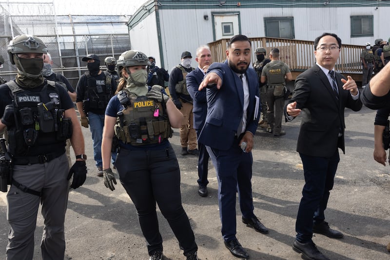 U.S. Sen. Andy Kim (D-NJ) (R) attempts to broker an agreement between ICE (Immigration Customs Enforcement) agents and pro-immigration activists outside the Delaney Hall migrant detention center