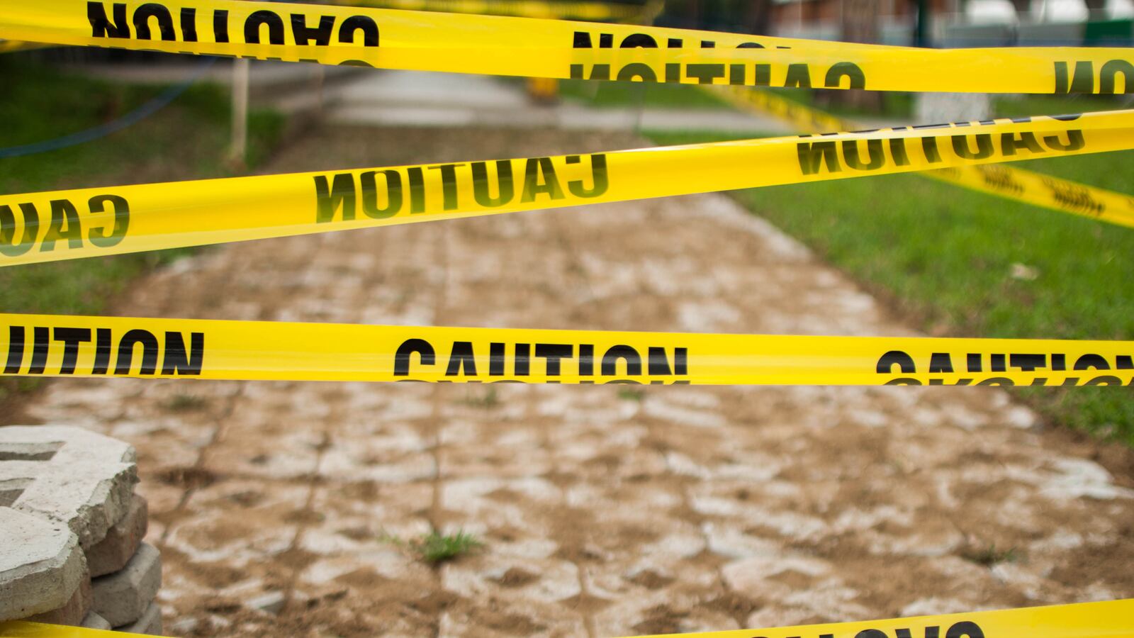 A close-up view of yellow tape caution sign outdoor during day time.