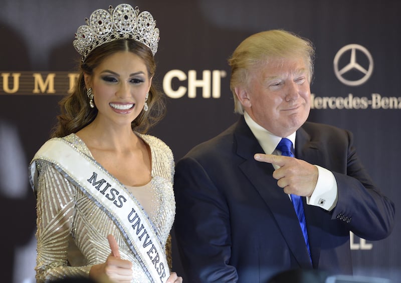 Donald Trump, then co-owner if the Miss Universe Organization posing next to Miss Venezuela and Miss Universe 2013 Gabriela Isler in Moscow on November 9, 2013.