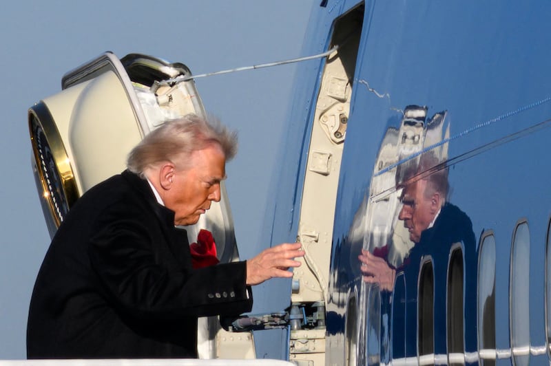 US President Donald Trump boards Air Force One before departing Detroit Metropolitan Wayne County Airport in Romulus, Michigan, on January 13, 2026. Trump is returning from speaking to The Detroit Economic Club in Detroit, Michigan, and a visit to a Ford production plant.