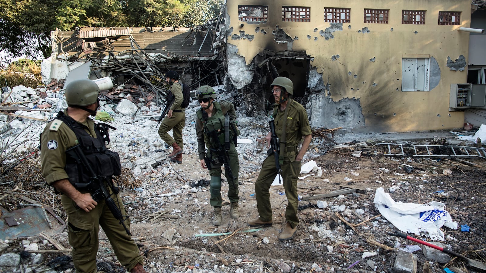 Israeli soldiers inspect houses that were destroyed in a battle between Israeli soldiers and Palestinian militants on Saturday's Hamas attack on the kibbutz on on October 14, 2023 in Be'eri, Israel.