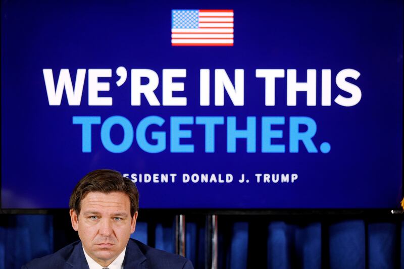 Gov. Ron DeSantis attends a 2020 event at a Florida golf club, featuring former President Donald Trump.