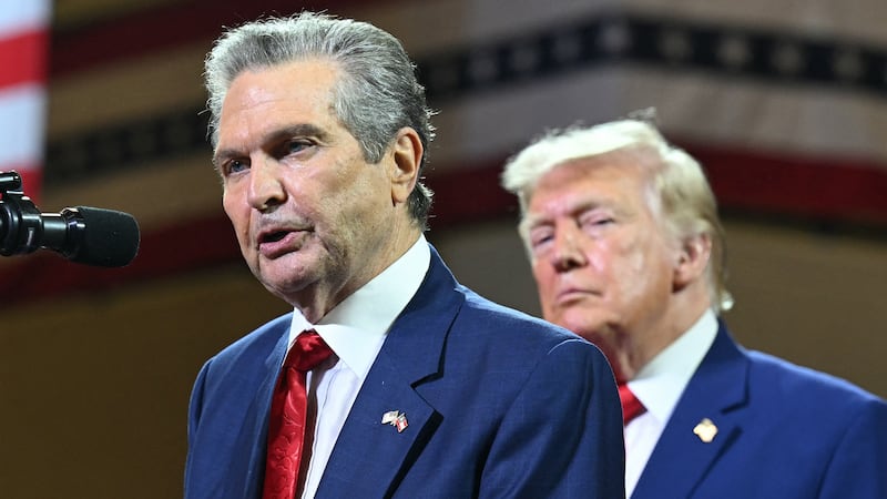 President Donald Trump (R) look on as Georgia's Republican Gubernatorial candidate Rick Jackson speaks at Wheeler High School in Marietta, Georgia, on July 22, 2026. (Photo by SAUL LOEB / AFP via Getty Images)