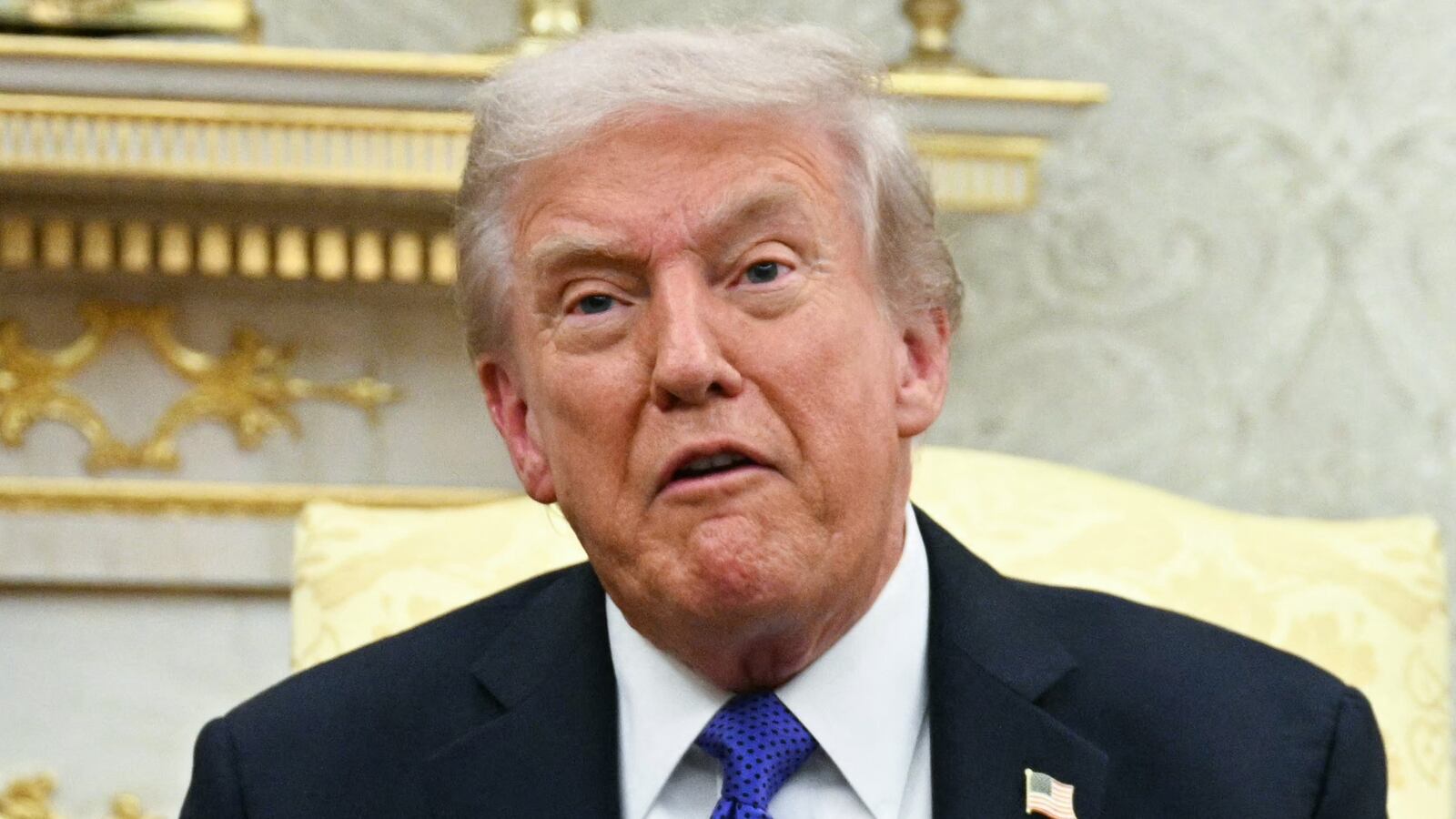 US President Donald Trump shows the floor plan of his planned ballroom.