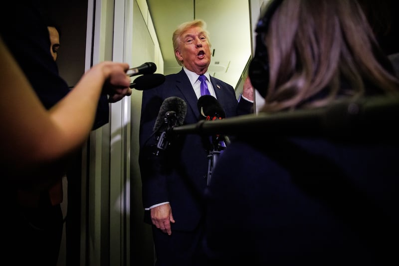 IN FLIGHT - FEBRUARY 06: U.S. President Donald Trump gaggles with reporters while aboard Air Force One on February 6, 2026 en route to Palm Beach, Florida. The President is spending the weekend at Mar-a-Lago, his private club. (Photo by Samuel Corum/Getty Images)