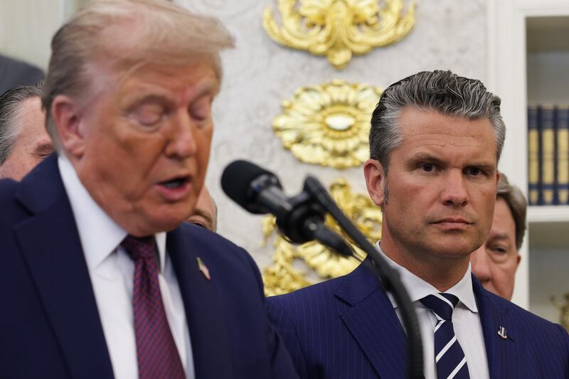Defense Secretary Pete Hegseth (R) looks on as U.S. President Donald Trump speaks in the Oval Office at the White House on September 02, 2025 in Washington, DC.