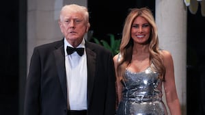 PALM BEACH, FLORIDA - DECEMBER 31: U.S. President Donald Trump and first lady Melania Trump arrive for a New Year’s Eve event at his Mar-a-Lago home on December 31, 2025 in Palm Beach, Florida. The president addressed guests and celebrated the arrival of 2026. (Photo by Joe Raedle/Getty Images)