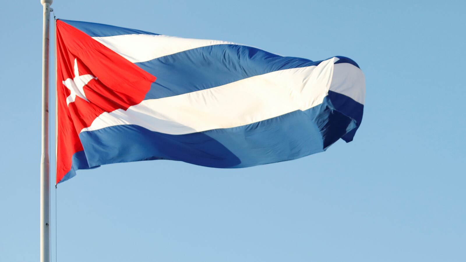 Cuba’s President Miguel Diaz-Canel and former President Raul Castro wave national flags as thousands march to Revolution Square to mark May Day, in Havana, Cuba, May 1, 2022.