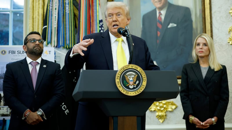 U.S. President Donald Trump speaks as Federal Bureau of Investigation Director Kash Patel (L) and U.S. Attorney General Pam Bondi look on during a press conference in the Oval Office of the White House on October 15, 2025 in Washington, DC.