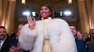Trinidadian rapper and singer-songwriter Nicki Minaj stands as she is recognized by US President Donald Trump as he delivers remarks on 'Trump Accounts' at the Andrew W. Mellon Auditorium in Washington, DC, on January 28, 2026. (Photo by Brendan SMIALOWSKI / AFP via Getty Images)