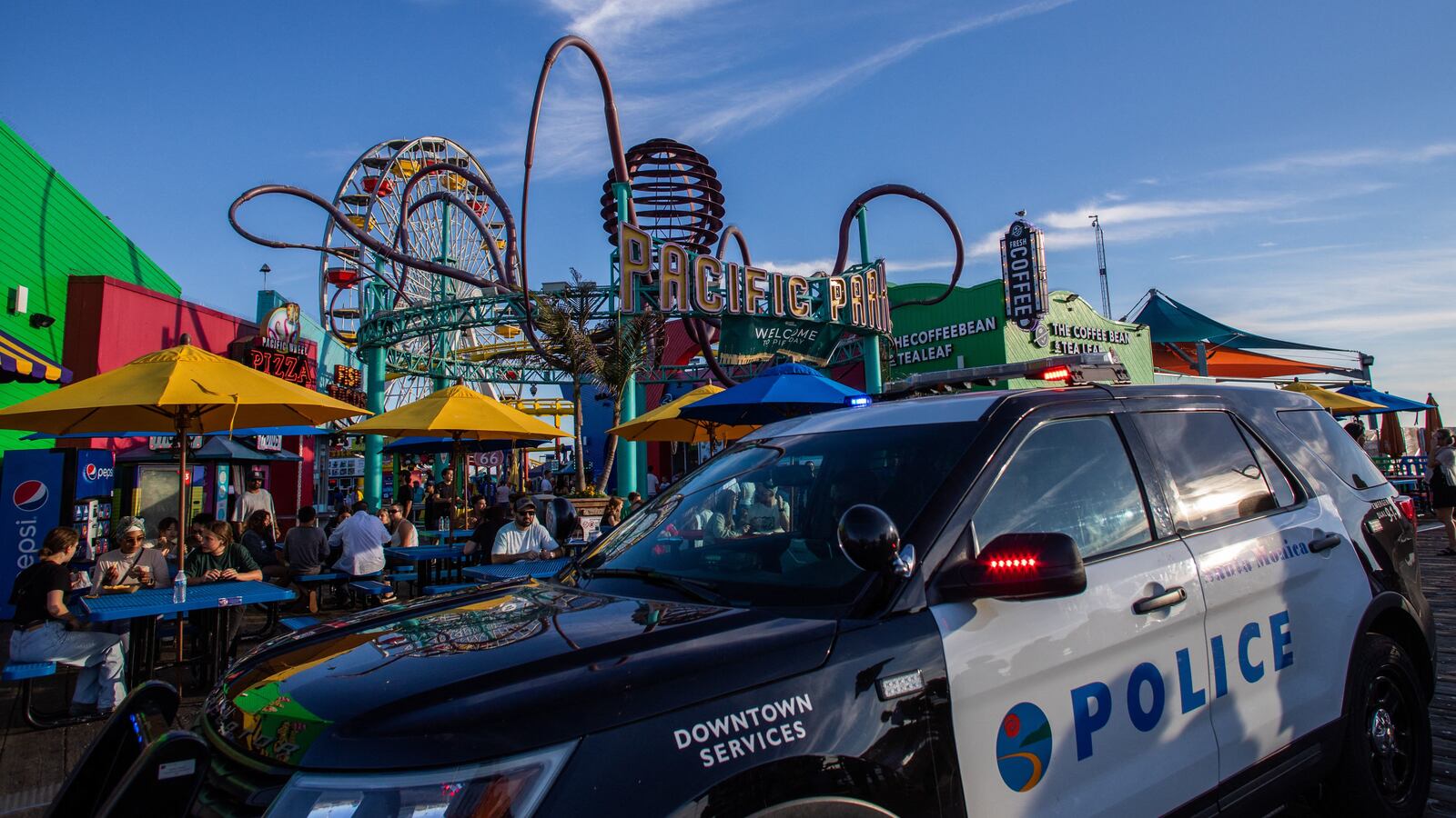 A police vehicle sits at Santa Monica Pier after a man, who claimed to have a bomb, climbed the ferris wheel and refused to come down