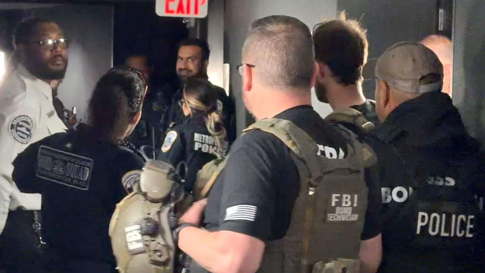 A group of uniformed men in a corridor