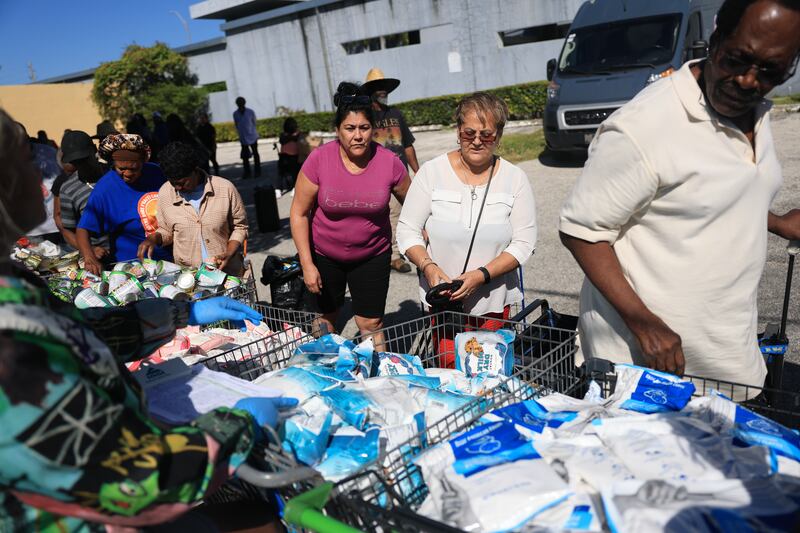 People receive groceries in Flordia from the Curley's House Food Bank days before the Supplemental Nutrition Assistance Program (SNAP) benefits may expire
