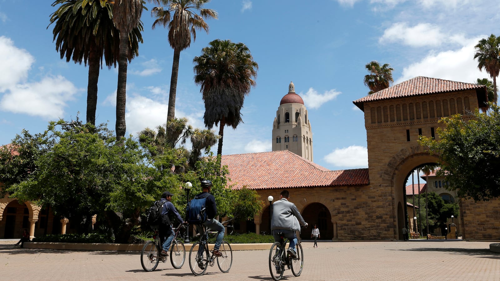 Cyclists ride on the campus of Stanford University.