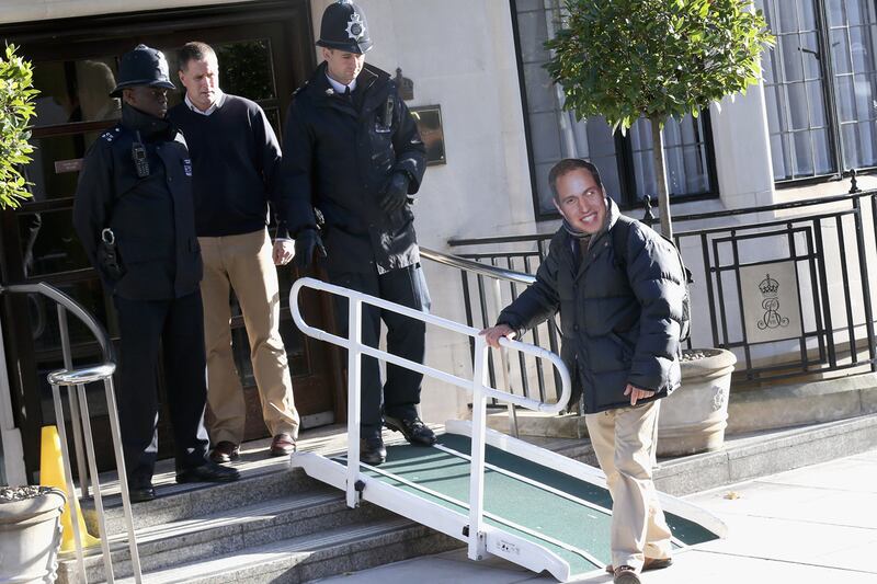 articles/2012/12/04/william-arrives-at-hospital-as-masked-prankster-is-lead-away/will-mask_fapds0