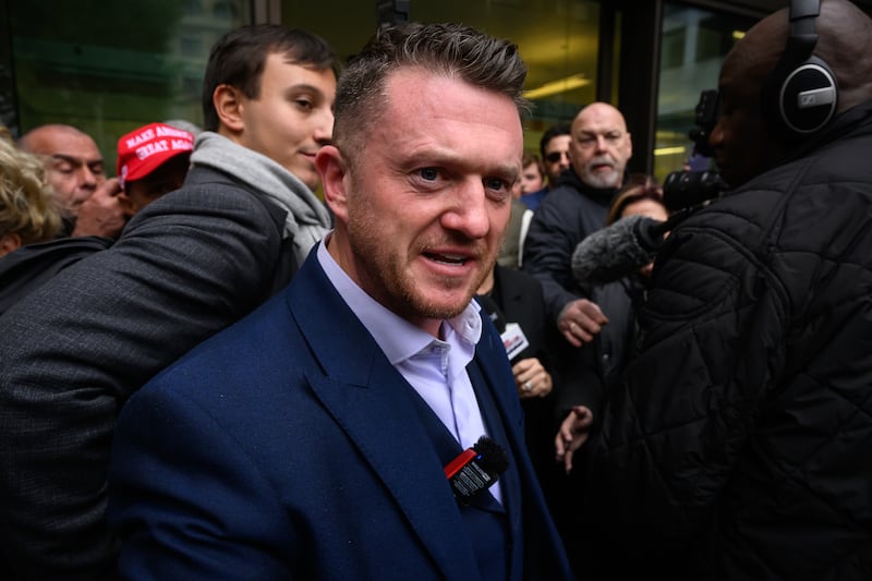 LONDON, ENGLAND - OCTOBER 13: Stephen Yaxley-Lennon, known as Tommy Robinson, speaks to supporters as he leaves at the end of day one of his two-day trial at Westminster Magistrates' Court on October 13, 2025 in London, England. Yaxley-Lennon, pleaded not guilty to failing to comply with counter-terrorism powers, after he refused to give police his mobile phone PIN when he was stopped at the entry Channel Tunnel in July 2024. (Photo by Leon Neal/Getty Images)