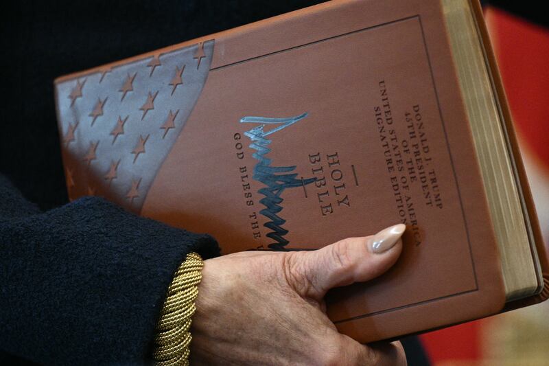 US Attorney for the District of Columbia Jeanine Pirro holds the Holy Bible  signed by Trump before Gor's swearing-in.
