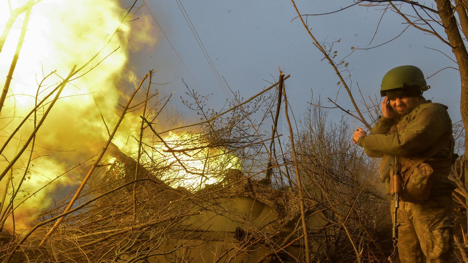 A Ukrainian serviceman stands next to a 2S3 Akatsiia self-propelled howitzer during firing towards Russian troops near the frontline town of Bakhmut, in Donetsk region, Ukraine April 12, 2023.