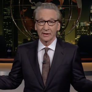 Bill Maher stands on the set of his eponymous late-night show during the monologue segment.