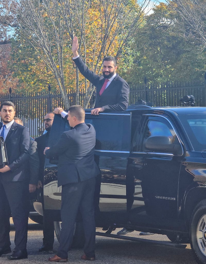 Syria's President Ahmed al-Sharaa greets supporters in the street outside the White House after he met with U.S. President Donald Trump in Washington, D.C., U.S., November 10, 2025.