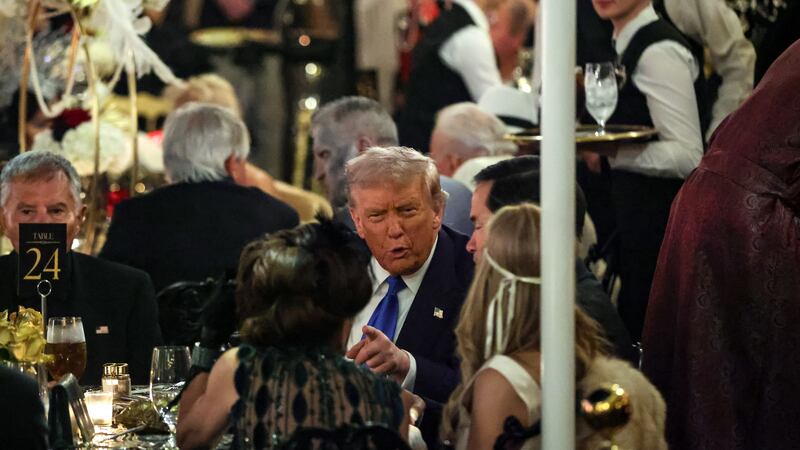 PALM BEACH, FLORIDA - OCTOBER 31: US President Donald Trump talks with guests during a Halloween party at his Mar-a-Lago estate on October 31, 2025 at Palm Beach, Florida. Trump is spending the weekend at his Mar-A-Lago estate in Palm Beach, Florida. (Photo by Samuel Corum/Getty Images)