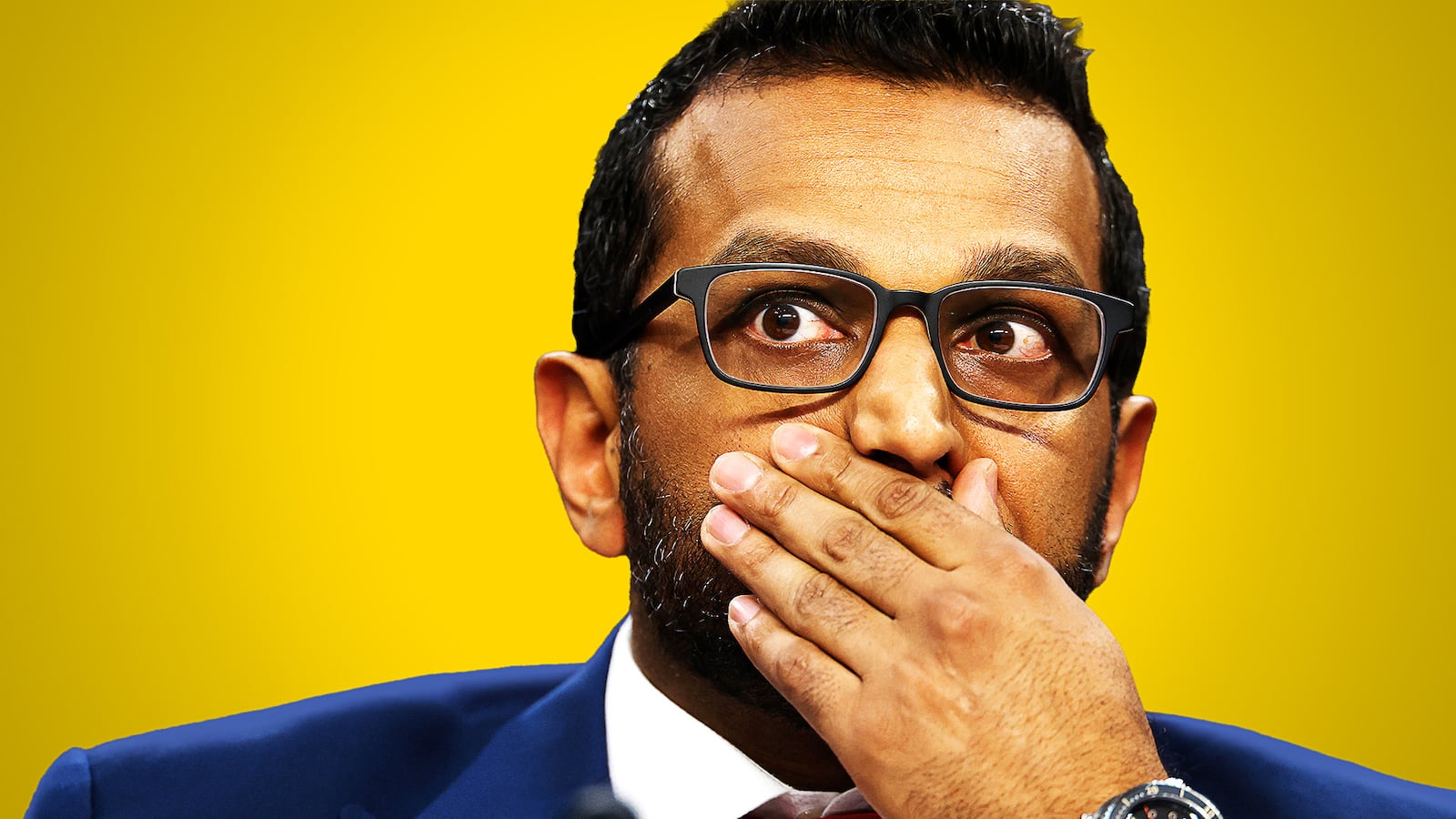 Kash Patel with his hand over his mouth.