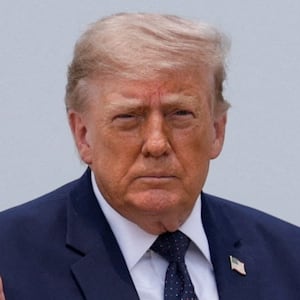 President Donald Trump gestures on the tarmac, as he heads to board the new Qatari-gifted Air Force One en route to New York City, at Joint Base Andrews, Maryland on July 17, 2026.