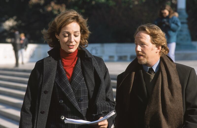 Allison Janney as C.J. Cregg and Timothy Busfield as Danny Concannon in The West Wing.