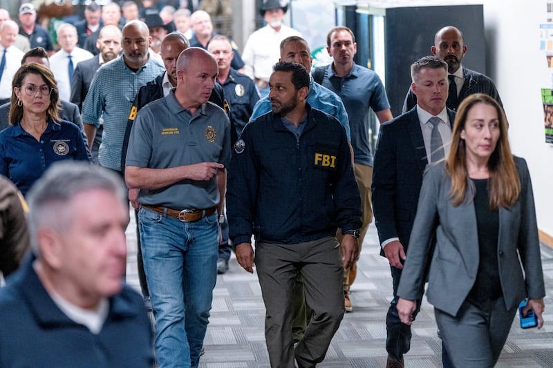 FBI Director Kash Patel walks with Utah Governor Spencer Cox as he visits the scene at the Utah Valley University, after U.S. right-wing activist and commentator, Charlie Kirk, an ally of U.S. President Donald Trump, was fatally shot during an event at the university, in Orem, Utah, U.S. September 11, 2025.