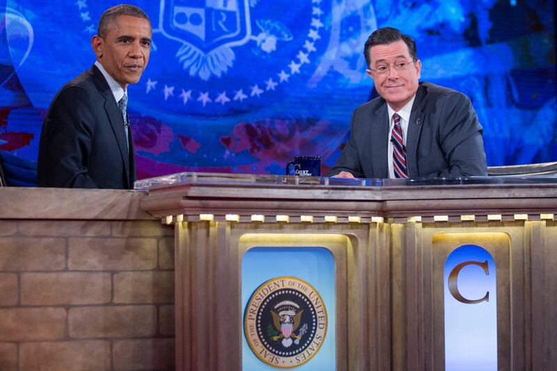 U.S. President Barack Obama, left, tapes Comedy Central's "The Colbert Report" with television personality Stephen Colbert in Lisner Auditorium at George Washington University in Washington, D.C., U.S., on Monday, Dec. 8, 2014. This is President Obama's third appearance on "The Colbert Report" that will broadcast its final show on Dec. 18.   (Photo by Andrew Harrer/WHITE HOUSE POOL (ISP POOL IMAGES)/Corbis/VCG via Getty Images)