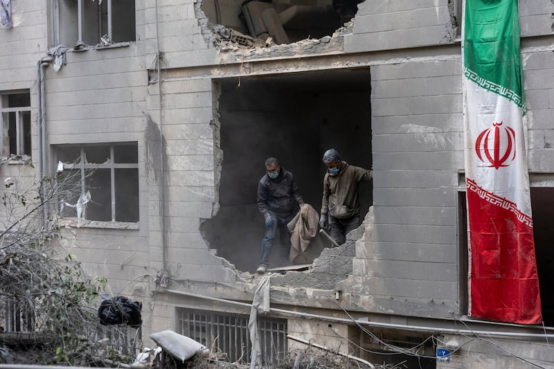 TEHRAN, IRAN - MARCH 15: People clear rubble in a house in the Beryanak District after it was damaged by missile attacks two days before, on March 15, 2026 in Tehran, Iran. The United States and Israel continued their joint attack on Iran that began on February 28. Iran retaliated by firing waves of missiles and drones at Israel, and targeting U.S. allies in the region. (Photo by Majid Saeedi/Getty Images)